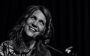 Ellen Reid BW at piano smile